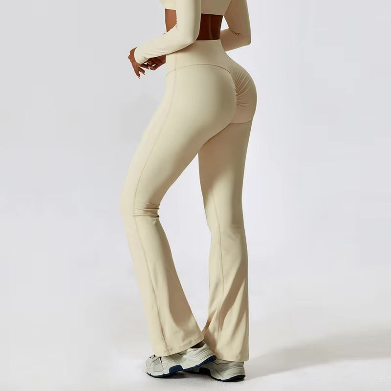 A woman posing in high-waisted, beige leggings