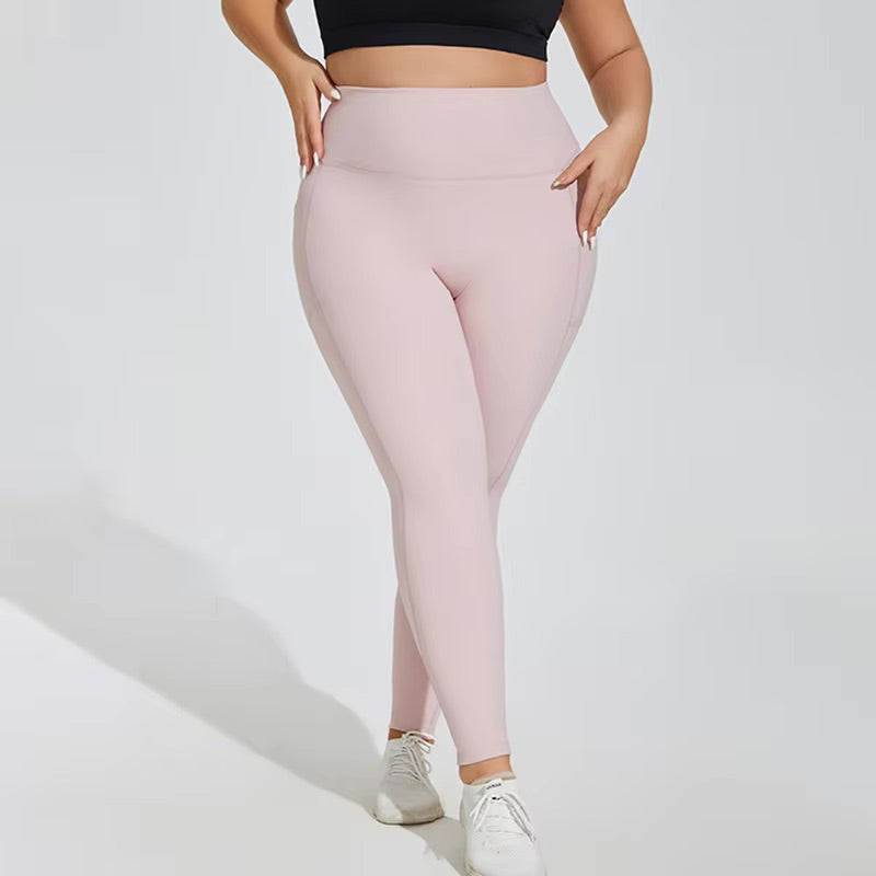 Woman posing in light pink leggings