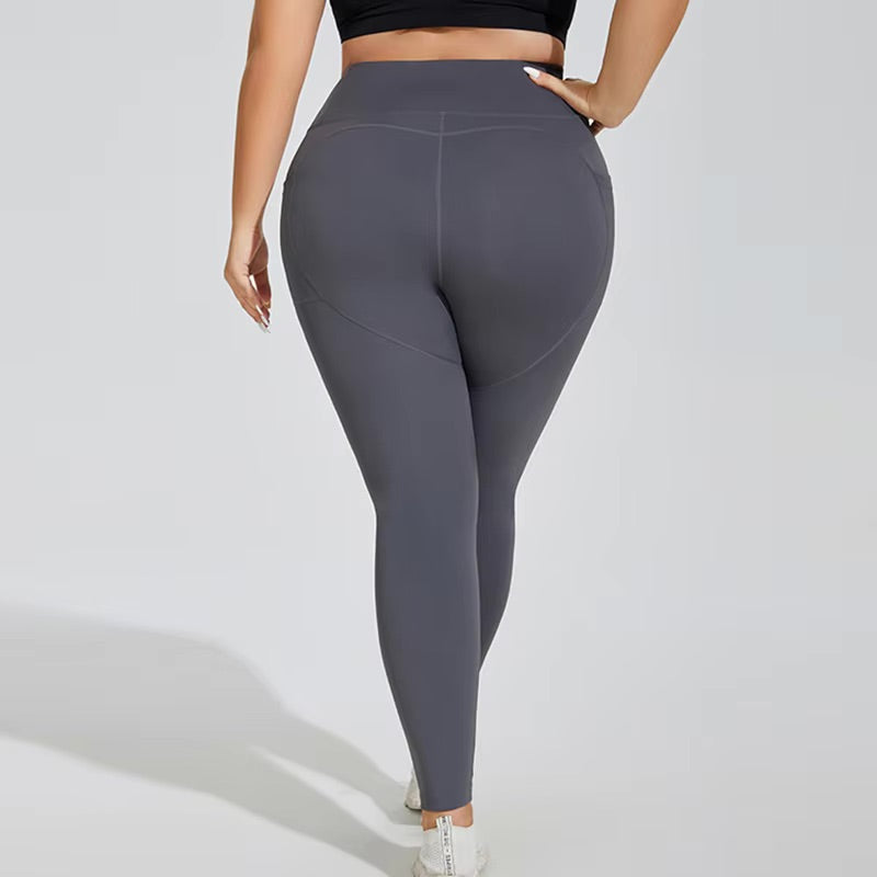 Woman posing in grey leggings