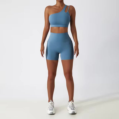 A woman posing in a matching set consisting of a cut-out sports bra and shorts in light blue color