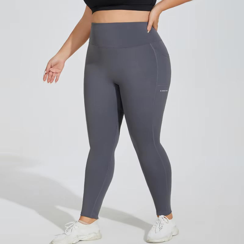 Woman posing in grey leggings