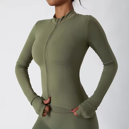 Woman posing in an olive green top with a zipper