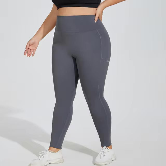 Woman posing in grey leggings