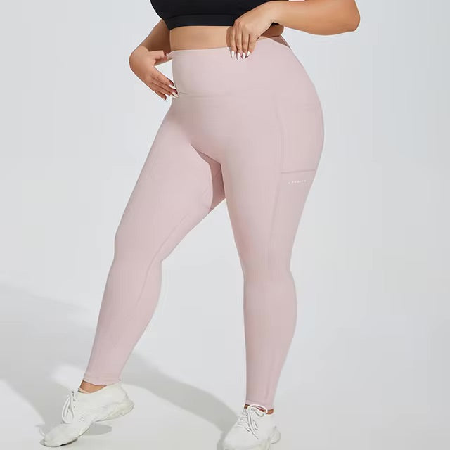 Woman posing in light pink leggings