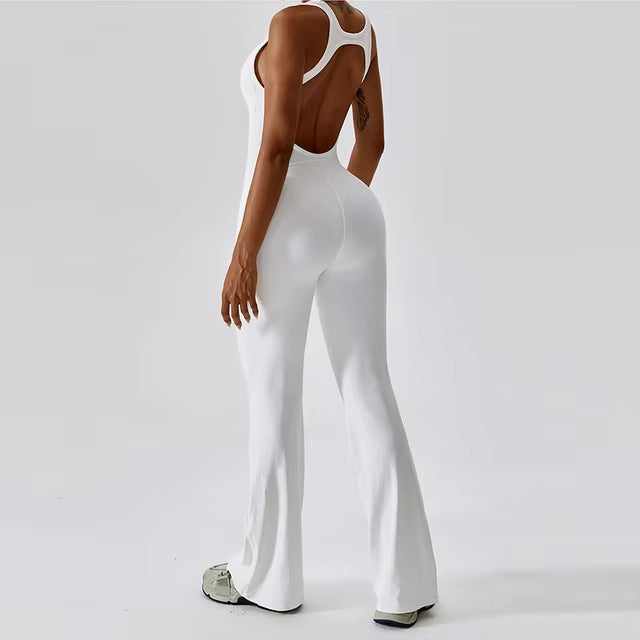 Woman posing in a white yoga jumpsuit