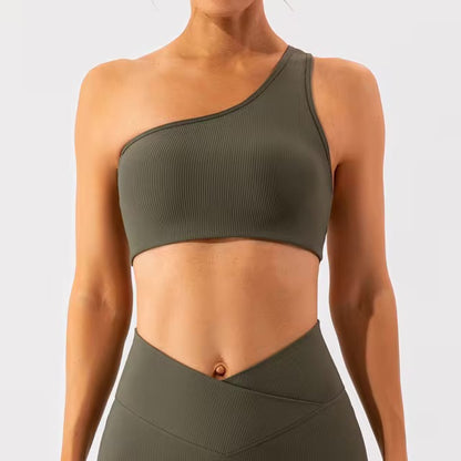 A woman posing in an olive green sports bra 