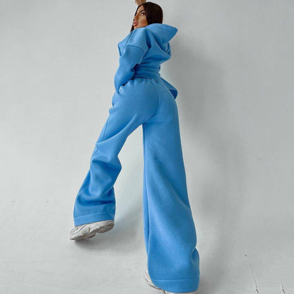 A woman posing in a blue oversized hoodie with matching sweatpants