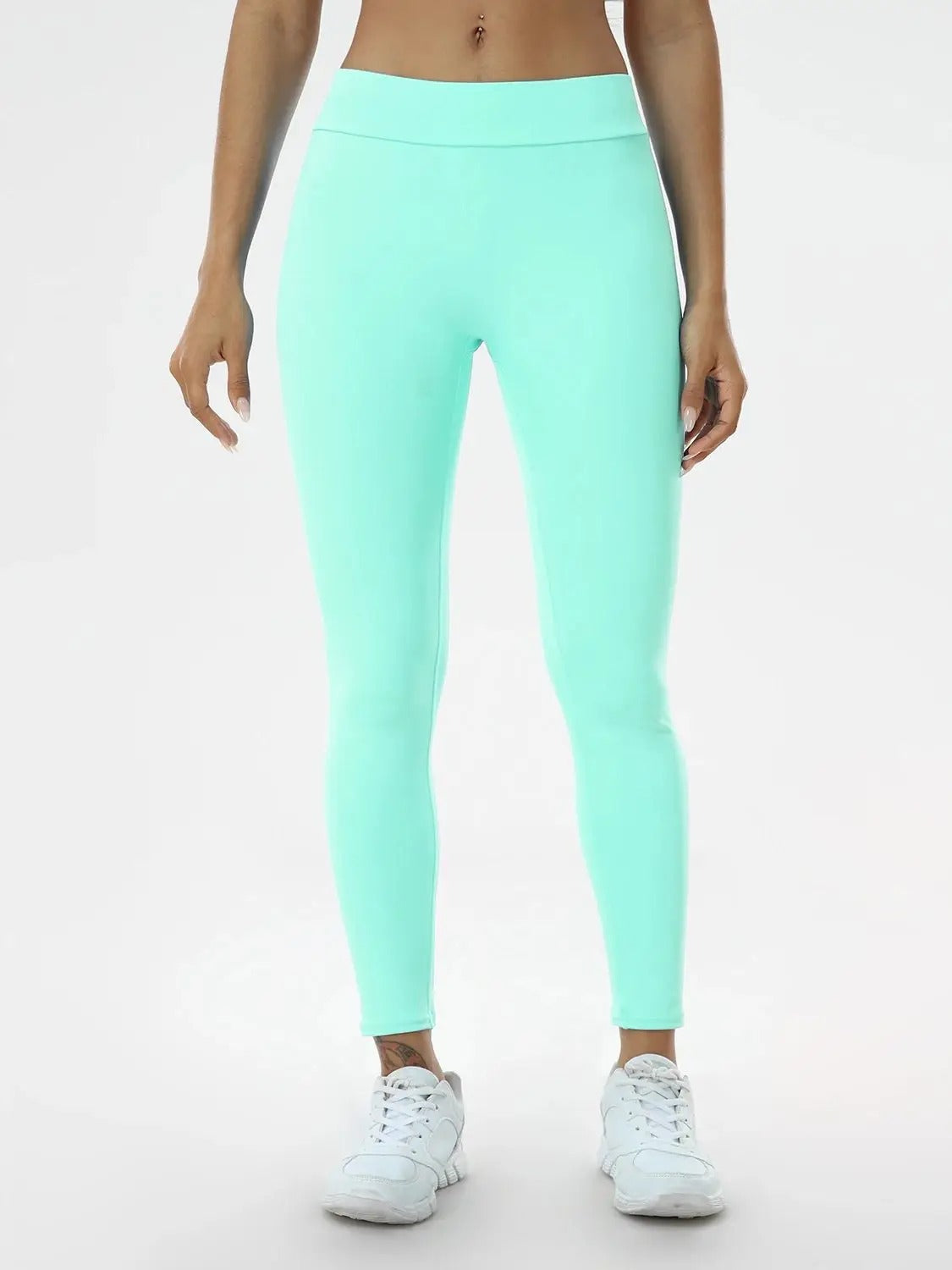 Woman posing in mint colored leggings