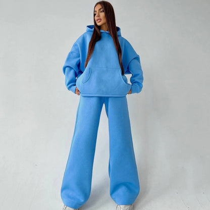 A woman posing in a blue oversized hoodie with matching sweatpants