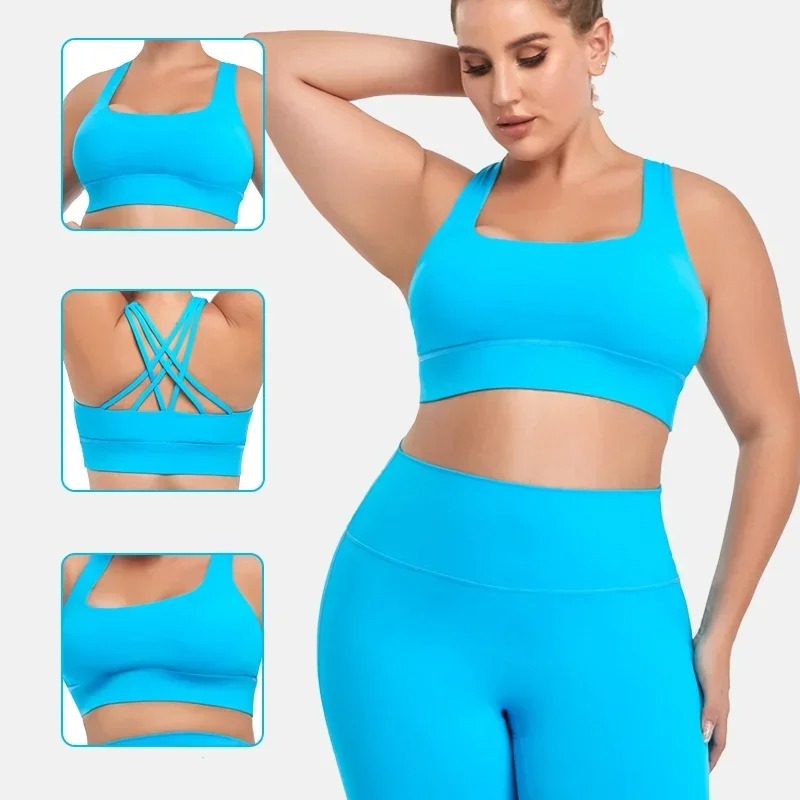 A woman posing in a light blue sports bra with matching leggings