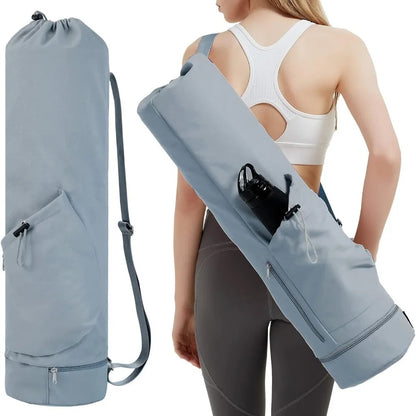 Woman carrying a light blue yoga mat bag 