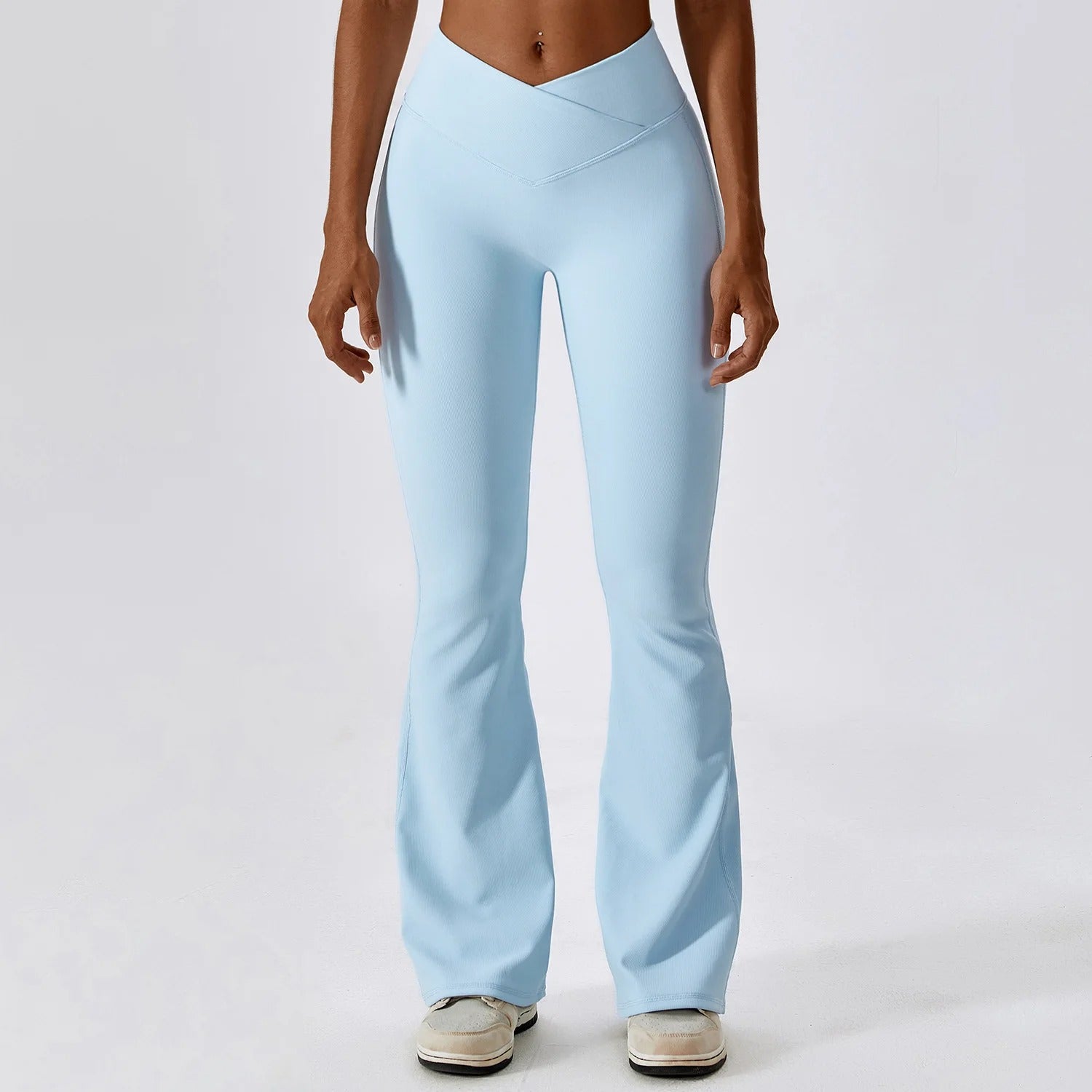 A woman posing in light blue leggings