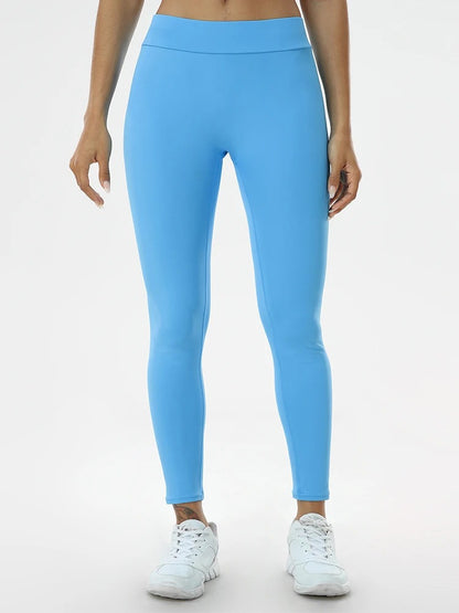 Woman posing in light blue leggings