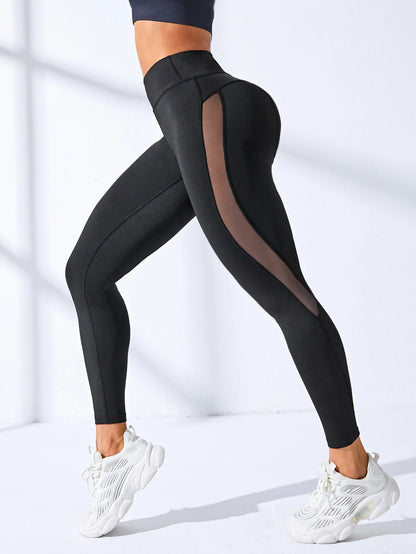 A woman posing in black leggings