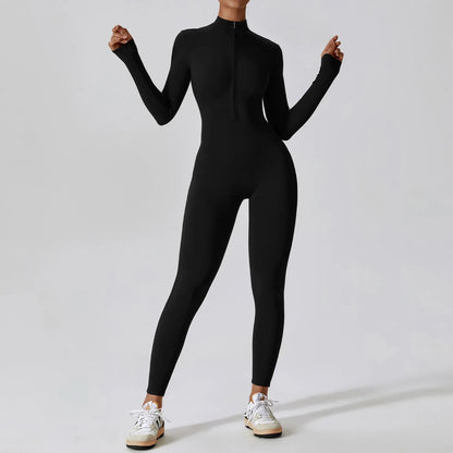 Woman posing in a long- sleeved, black, yoga jumpsuit with a zipper