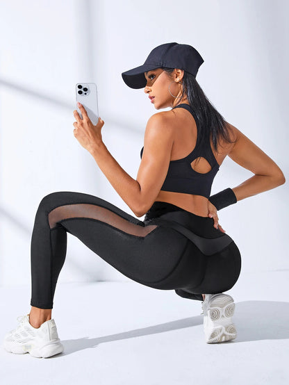 A woman posing in black leggings