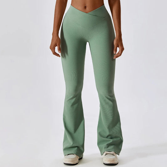 A woman posing in green leggings