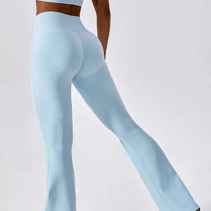 A woman posing in light blue leggings