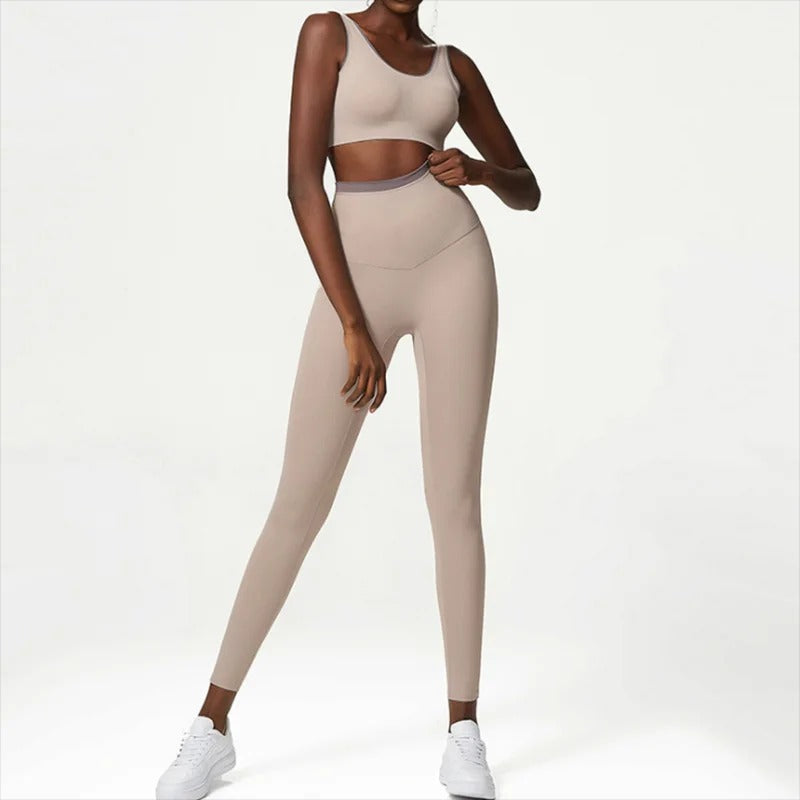 Woman posing in a beige workout set consisting of leggings and a sports top