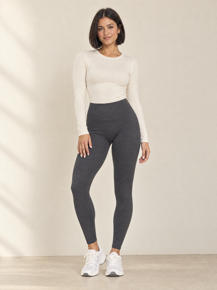 Petite woman in charcoal full-length leggings